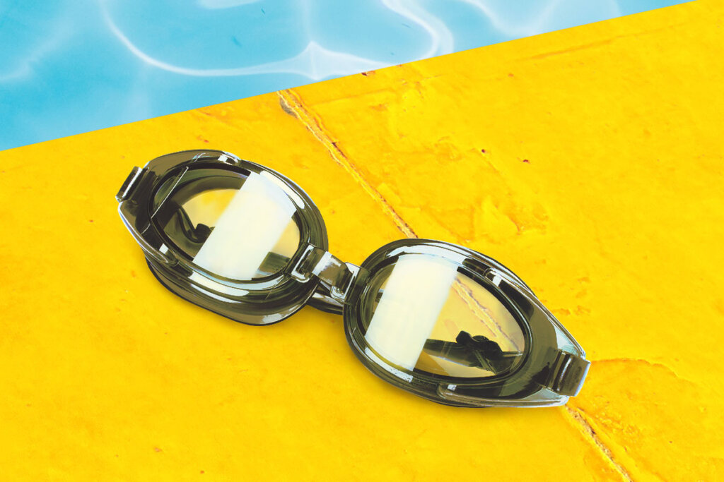 Lunettes de natation sur bord de piscine jaune